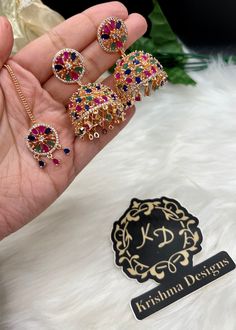 Beautiful American Diamond Jhumki Earrings with Tikka| Perfect for Wedding and Party wear occassion | High end AD earrings| gifts for her| Pink, Multi ad jhumka tikka set ⭐️Made with the Finest & High End Quality.  ⭐️ Set comes with Jhumki/Jhumka style earrings and mang tikka. Material- American Diamond Colors- -Multi - Pink High End Quality 100% Satisfaction Guarantee: Long Lasting Plating, High-Quality Stones. Perfect for any occassion-Western, Indian and Casual day looks.  Care: It is advisab Fusion Style Jhumkas For Diwali Party, Fusion Style Earrings For Wedding And Navratri, Party Chandbali Jhumkas Hand Set, Hand Set Chandbali Jhumkas For Party, Multicolor Drop Earrings Jhumkas For Festive Season, Multicolor Jhumkas With Matching Earrings For Diwali, Festive Hand Set Jhumkas For Party, Multicolor Jhumkas For Diwali With Matching Earrings, Fusion Style Chandbali Jhumkas For Party