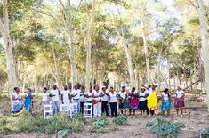 a group of people standing next to each other in the woods