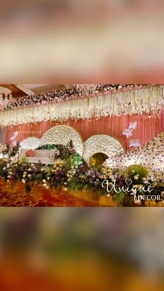 an image of a wedding stage setting with flowers on the ceiling and chandeliers hanging from the ceiling