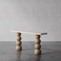 a wooden bench sitting on top of a cement floor