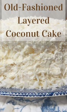 an old - fashioned layered coconut cake on a blue and white plate with text overlay