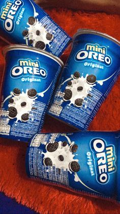 three cans of oreo ice cream sitting on top of a towel