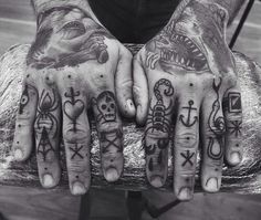 black and white photograph of two hands with tattoos on them