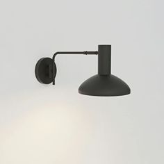 a black wall light with a white background