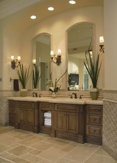 a large bathroom with double sinks and mirrors