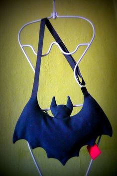 a bat hanging from a hook on a wall