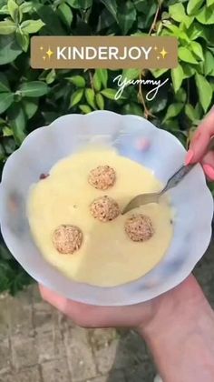 a person holding a plate with some food on it and a knife in the bowl