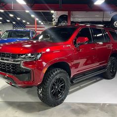 a red truck is parked in a showroom