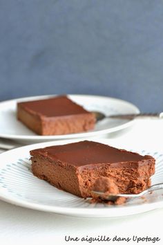 two plates with slices of chocolate cake on them