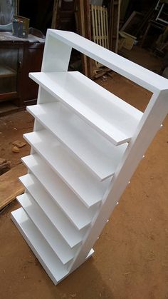 a large white shelf sitting on top of a wooden floor