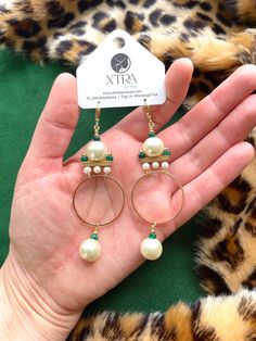 These gorgeous and unique statement hoops were designed in the art deco style of the 1920's. These are the perfect earrings for dressing up your holiday attire.These hoop earrings hang approximately 3.5" from the lobe and measure approximately 1.25" inches at their widest point. The design contains 12mm faux pearls, 4mm faux pearls, 3mm malachite heishi beads, and gold plated brass components.The leverback closure is 22k gold plated and should be suitable for sensitive ears. These are semi-light Elegant Brass Hoop Earrings For Party, Bohemian Round Hoop Earrings For Party, Elegant Beaded Hoop Earrings For Party, Nickel-free Brass Hoop Earrings For Party, Nickel Free Brass Hoop Earrings For Party, Party Brass Hoop Earrings With Ear Wire, Party Brass Hoop Earrings, Elegant Metal Hoop Chandelier Earrings, Elegant Metal Chandelier Hoop Earrings