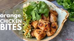 an orange chicken bites dish with lettuce and cilantro on the side