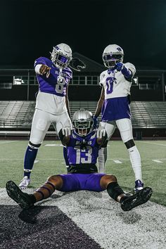 two football players standing next to each other on a field