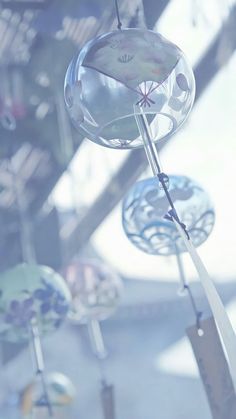 an assortment of wind chimes hanging from the ceiling