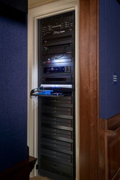 there is a very large stack of electronic equipment in the room that has blue walls