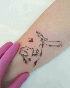 a woman's arm with a tattoo on it and a heart in the middle