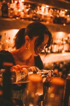 a woman pouring drinks at a bar