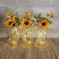 sunflowers and baby's breath in mason jars on a burlocked placemat