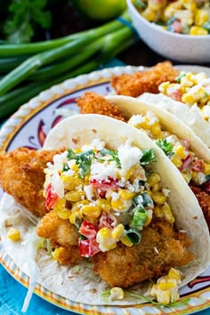 three fish tacos with corn on the cob