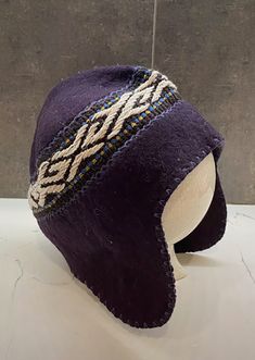 a purple hat sitting on top of a white table