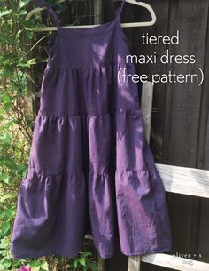 a purple dress hanging on a clothes line with the words tiered midi dress free pattern