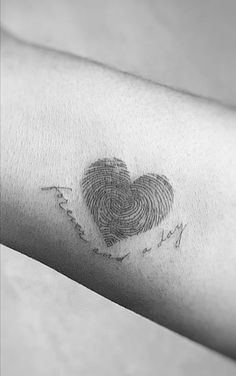 a fingerprint in the shape of a heart on someone's left arm that has been drawn onto it