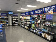 an empty grocery store filled with items and signs for water, food, and more