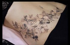 a close up of a woman's stomach with flowers on it