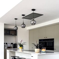 a kitchen with two stools next to a counter and an island in the middle