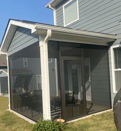 an enclosed patio area in front of a house