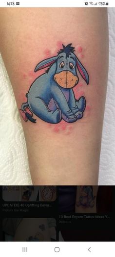 an image of a cartoon character tattoo on someone's leg, with the words up at