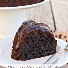 a piece of chocolate cake sitting on top of a white plate