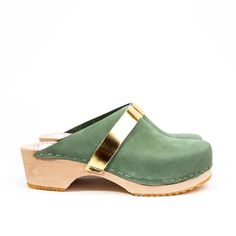 Green nubuck leather classic clog with gold strap. Wooden sole, 4,5 cm heels. Handmade in Sweden. The shoe runs slightly large in size. If choosing between two sizes, pick the smaller! Do you have questions or need additional information? Please contact us on sofie@liliandlala.com. www.liliandlala.com Lili & Lala was founded by Swedish Alexandra Giertz in India in 2014. Lili & Lala is now Stockholm based and run by Sofie Egebrant and Alexandra Giertz. We make clothes and shoes for girls Cheap Green Slip-on Clogs, Cheap Green Closed Toe Clogs, Swedish Clogs, Make Clothes, Clogs And Mules, Shoes For Girls, Wooden Clogs, Clothes And Shoes, Wooden Shoes