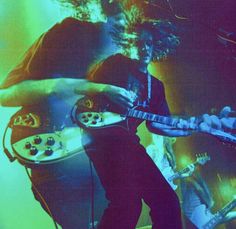 a man playing an electric guitar on stage