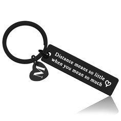 a black keychain that says distance means so little when you mean so much