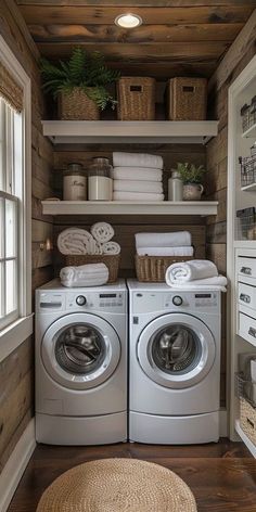 a washer and dryer in a small room with wood paneling on the walls