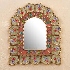 a decorative mirror mounted to the side of a wall