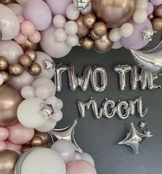 two the moon balloons and stars are arranged on a black background with white, pink, gold and silver balloons