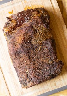 a piece of meat is sitting on a cutting board