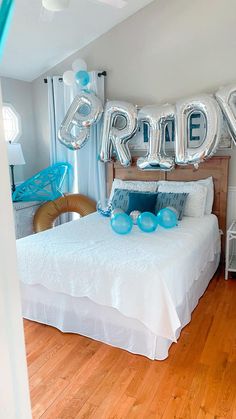 a bedroom with balloons that spell out the word bride