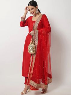 This is a beautiful 3 piece suit set. It comes with thread embellished straight cut kurta has 3/4th sleeves, round neck, calf length teamed with solid trouser pants and a net dupatta with zari & stones detailing. 3 piece set Color- Red Work- Beads & Zari Embellished Detailing Kurti Length - 46 inch Kurta Fabric-Silk Bottom Fabric - Silk Dupatta Fabric-Net with Zari & Stones Detailing Sleeves-3/4th Sleeves Neck-Round Neck Care - Dry Clean Note - The set does not include potli bag Luxury Red Straight Kurta Traditional Wear, Luxury Katan Silk Unstitched Suit For Festive, Luxury Red Kurta With Zari Work, Luxury Red Churidar For Eid, Luxury Katan Silk Unstitched Suit With Zari Work, Luxury Unstitched Straight Kurta Anarkali Set, Luxury Jamawar Churidar For Diwali, Luxury Anarkali Set With Meenakari Straight Kurta, Luxury Bollywood Silk Unstitched Suit