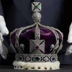 the crown is being held by two hands