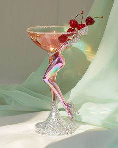 a pink martini with cherries on the rim