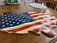 an american flag is sitting on top of a wooden table