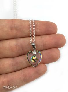 Unicorn Necklace - Rainbow Unicorn Pendant - 15x14mm Engraved Unicorn Heart Charm - Etched Glass with Unicorn Sterling Silver Chain Option This gorgeous Unicorn pendant is a miniature work of art! 15x14mm glass heart contains the carving of a rainbow unicorn and is surrounded by rainbow etchings along the edge. It's reversible - one side is flat with richer rainbow colors and the other side is carved with softer rainbow colors. Comes with a 20 inch sterling silver link chain or a silver plated l Unicorn Pendant, Silver Link Chain, Unicorn Necklace, Etched Glass, Rainbow Unicorn, Glass Heart, Glass Etching, Sterling Silver Chain, Link Chain