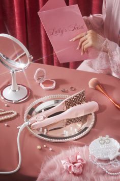 a table topped with lots of pink items