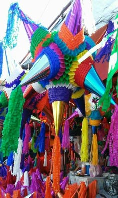 many colorful streamers are hanging from the ceiling