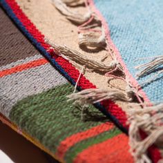 a multicolored blanket laying on top of a table