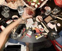 a table topped with lots of different types of food and wine glasses on top of it