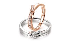 two wedding rings with diamonds on top and bottom, one in rose gold and the other in white gold